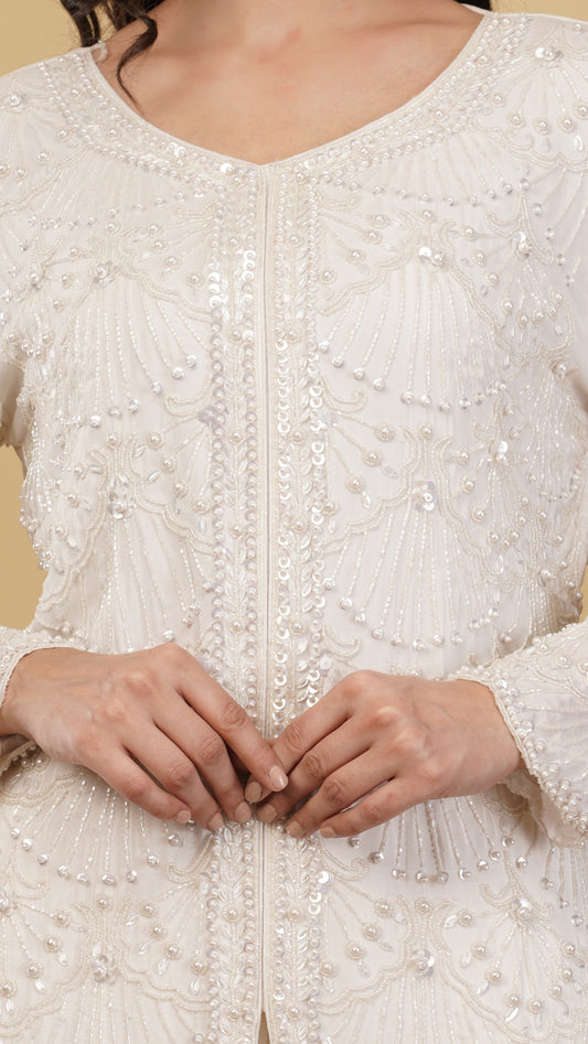 Close-up of a white embroidered garment with a beige background
